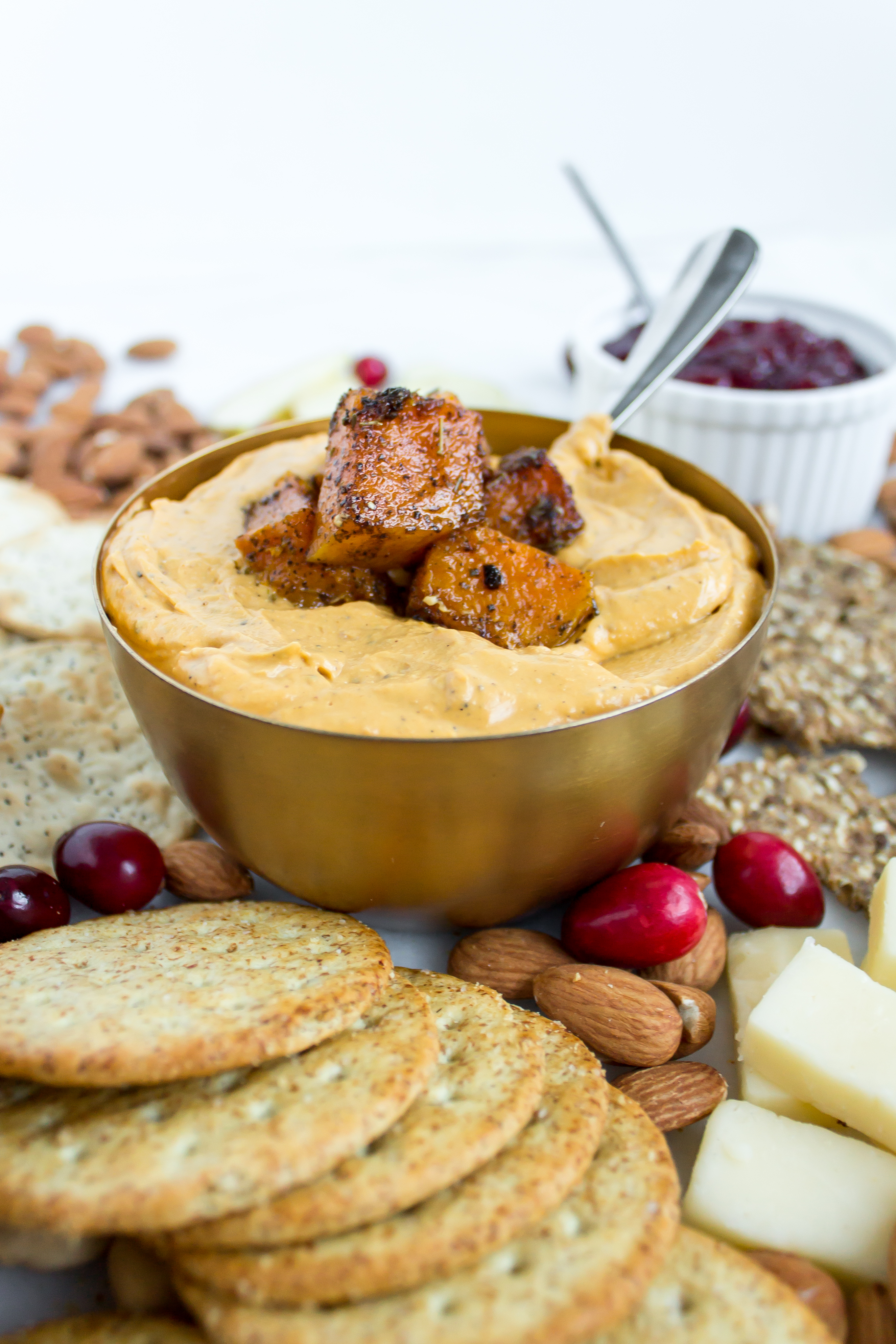 Filled with herbs, goat cheese, and caramelized butternut squash, this roasted butternut squash dip is perfect for all of your holiday appetizer platters and cheese boards. | www.passthecookies.com