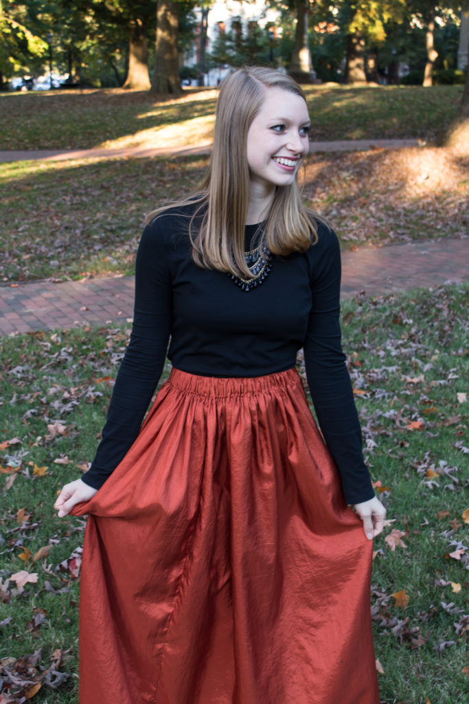 Pairing a simple black top with a fun burnt orange maxi skirt a statement necklace, and classic leopard flats is an easy way to create a great Halloween or fall outfit.  www.passthecookies.com