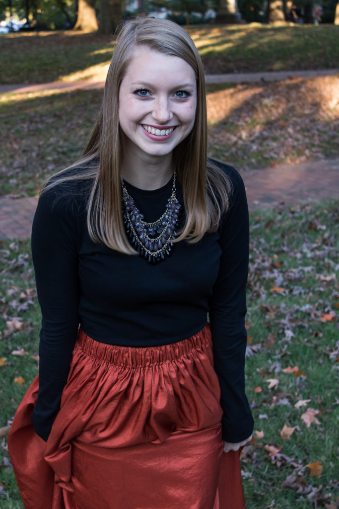 Pairing a simple black top with a fun burnt orange maxi skirt a statement necklace, and classic leopard flats is an easy way to create a great Halloween or fall outfit.  www.passthecookies.com