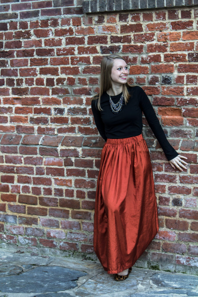 Pairing a simple black top with a fun burnt orange maxi skirt a statement necklace, and classic leopard flats is an easy way to create a great Halloween or fall outfit.  www.passthecookies.com