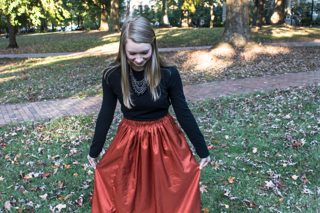 Pairing a simple black top with a fun burnt orange maxi skirt a statement necklace, and classic leopard flats is an easy way to create a great Halloween or fall outfit.  www.passthecookies.com