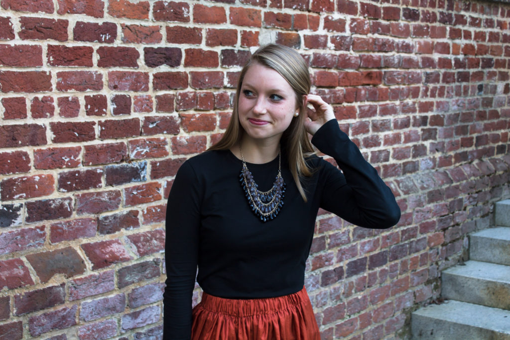 Pairing a simple black top with a fun burnt orange maxi skirt a statement necklace, and classic leopard flats is an easy way to create a great Halloween or fall outfit.  www.passthecookies.com