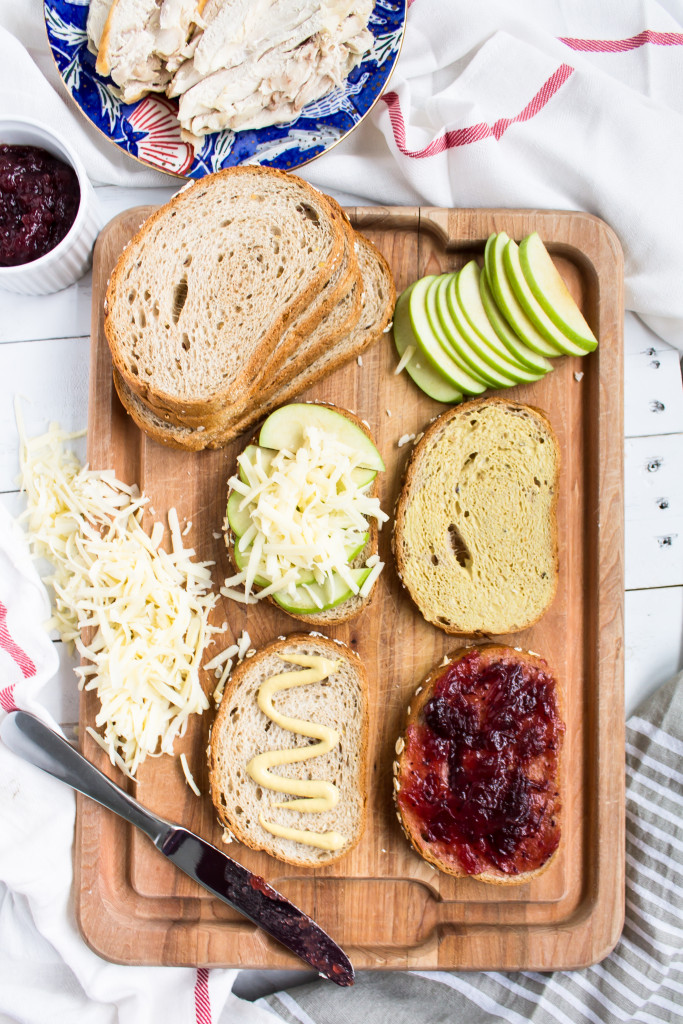 Filled with turkey, sweet cranberry sauce, tart apple slices, dijon, and gruyere, this Thanksgiving leftovers grilled cheese is easy, delicious and perfect for your day-after lunch. | Pass the Cookies | www.passthecookies.com