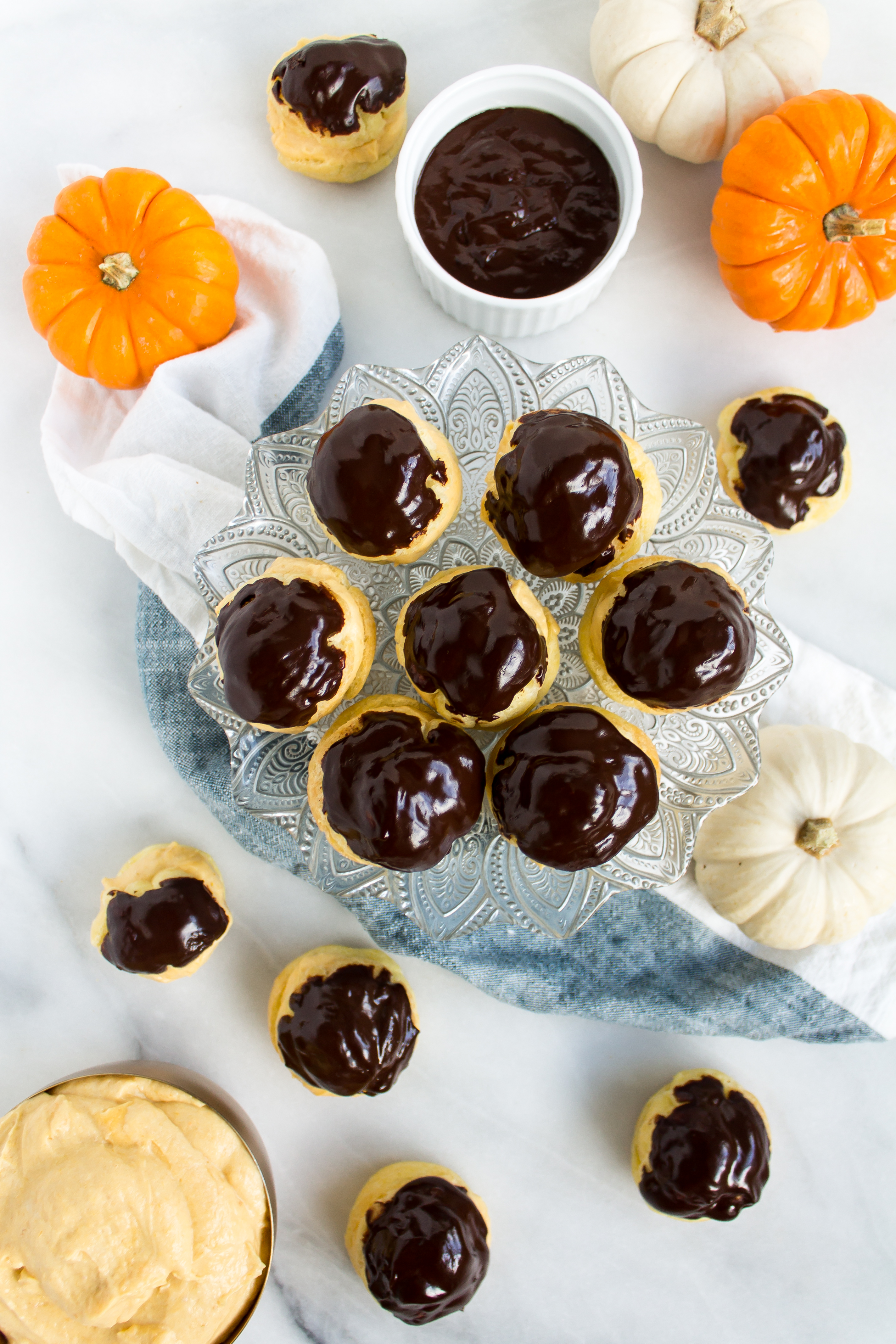 Impress your friends this season with fluffy, delicious pumpkin cream puffs with chocolate ganache. | www.passthecookies.com
