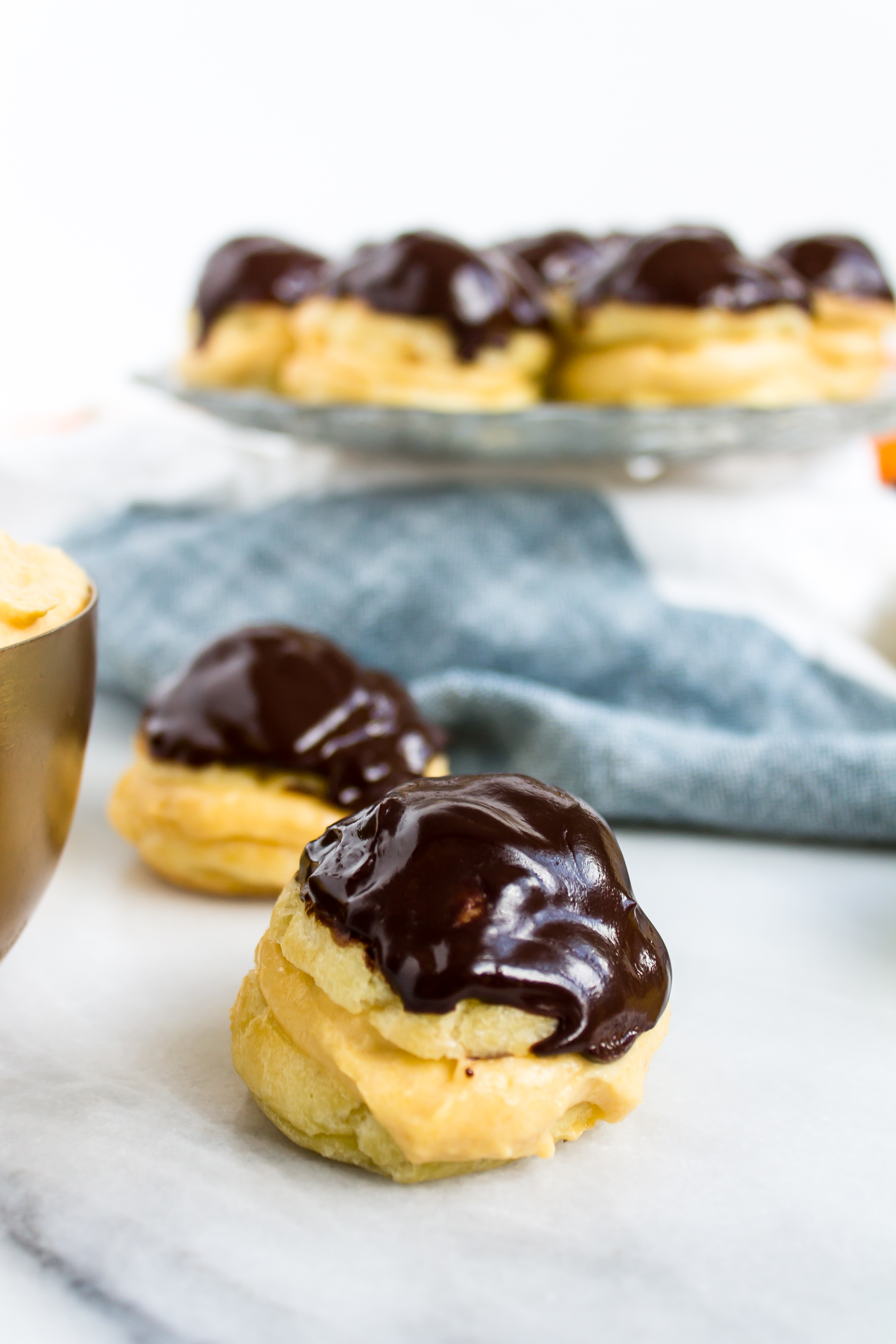 Impress your friends this season with fluffy, delicious pumpkin cream puffs with chocolate ganache. | www.passthecookies.com