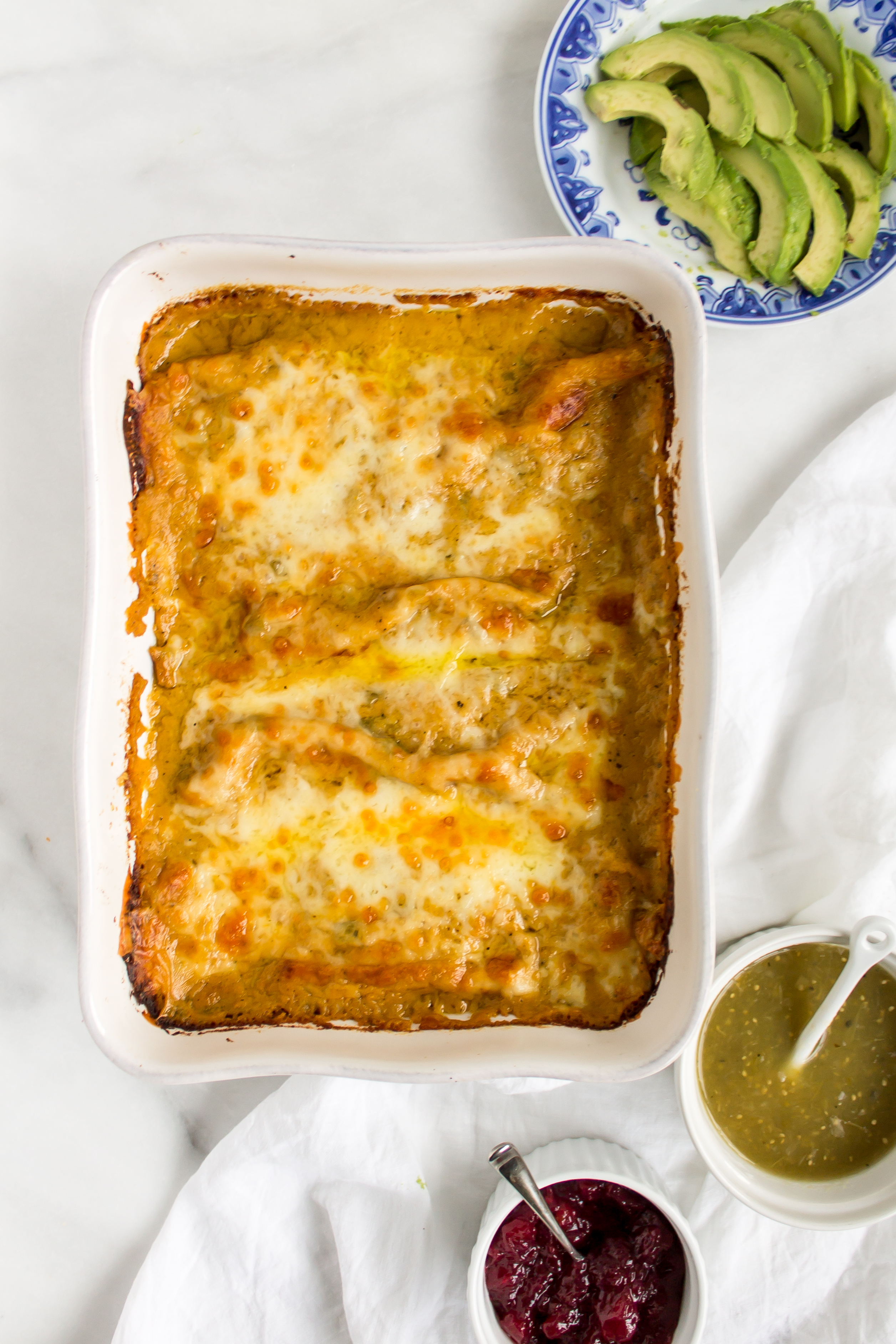 Turkey enchiladas with butternut squash sauce are the perfect way to use up Thanksgiving leftovers! | www.passthecookies.com