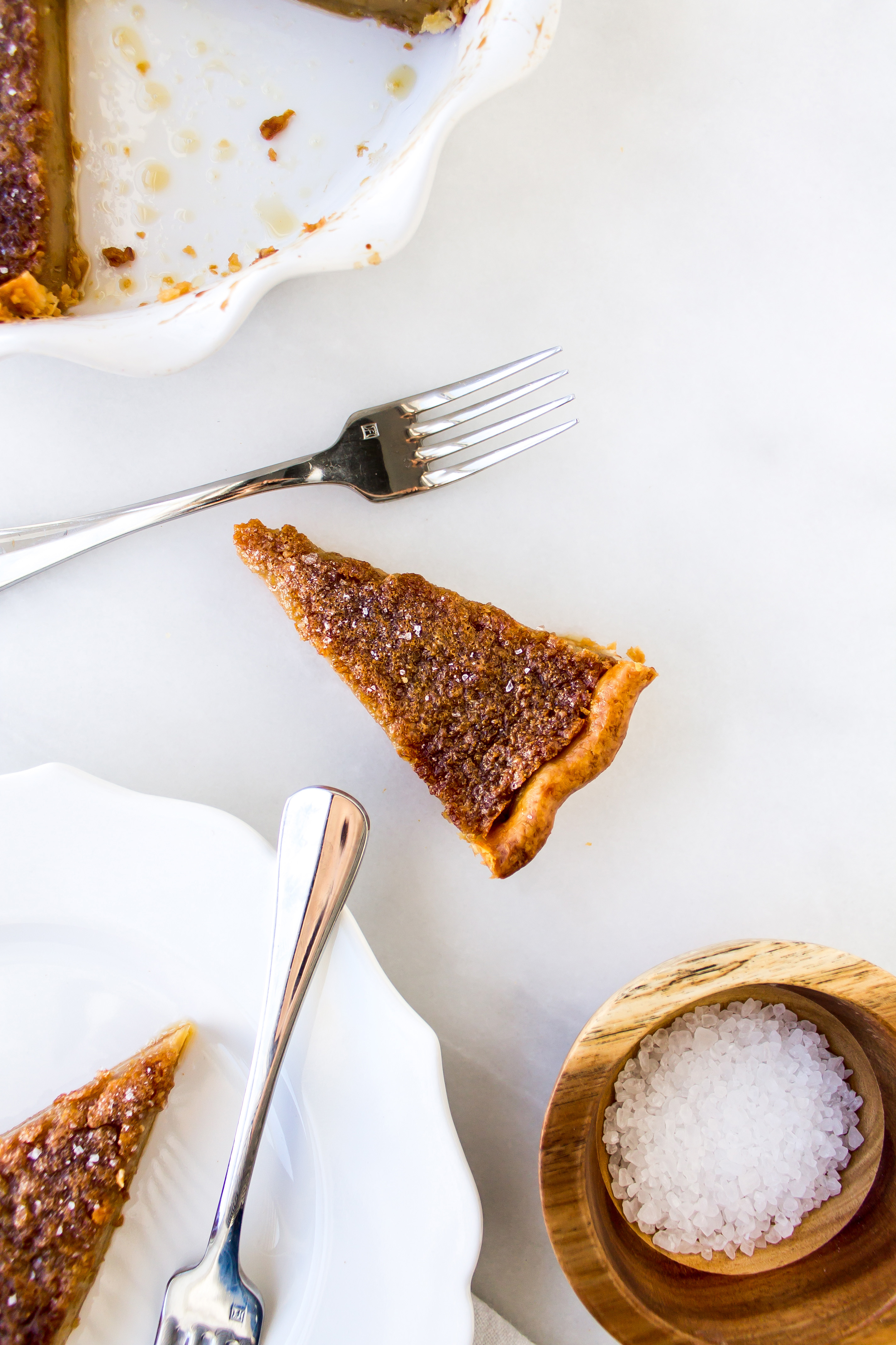Salted maple pie is perfectly chewy, filled with sweet rich maple syrup flavor, and topped with sea salt for that irresistible salty and sweet combination. | Pass the Cookies | www.passthecookies.com