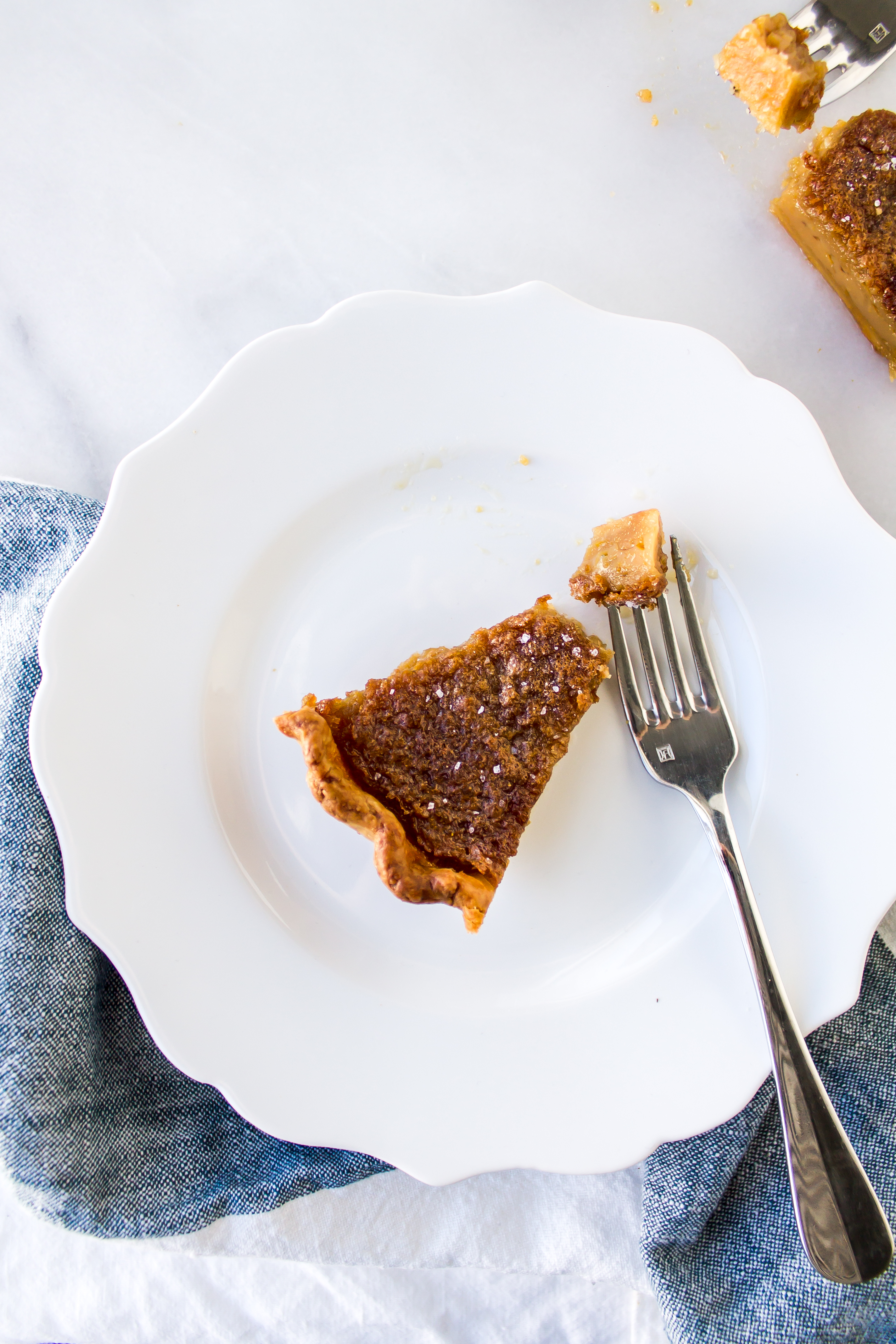 Salted maple pie is perfectly chewy, filled with sweet rich maple syrup flavor, and topped with sea salt for that irresistible salty and sweet combination. | Pass the Cookies | www.passthecookies.com